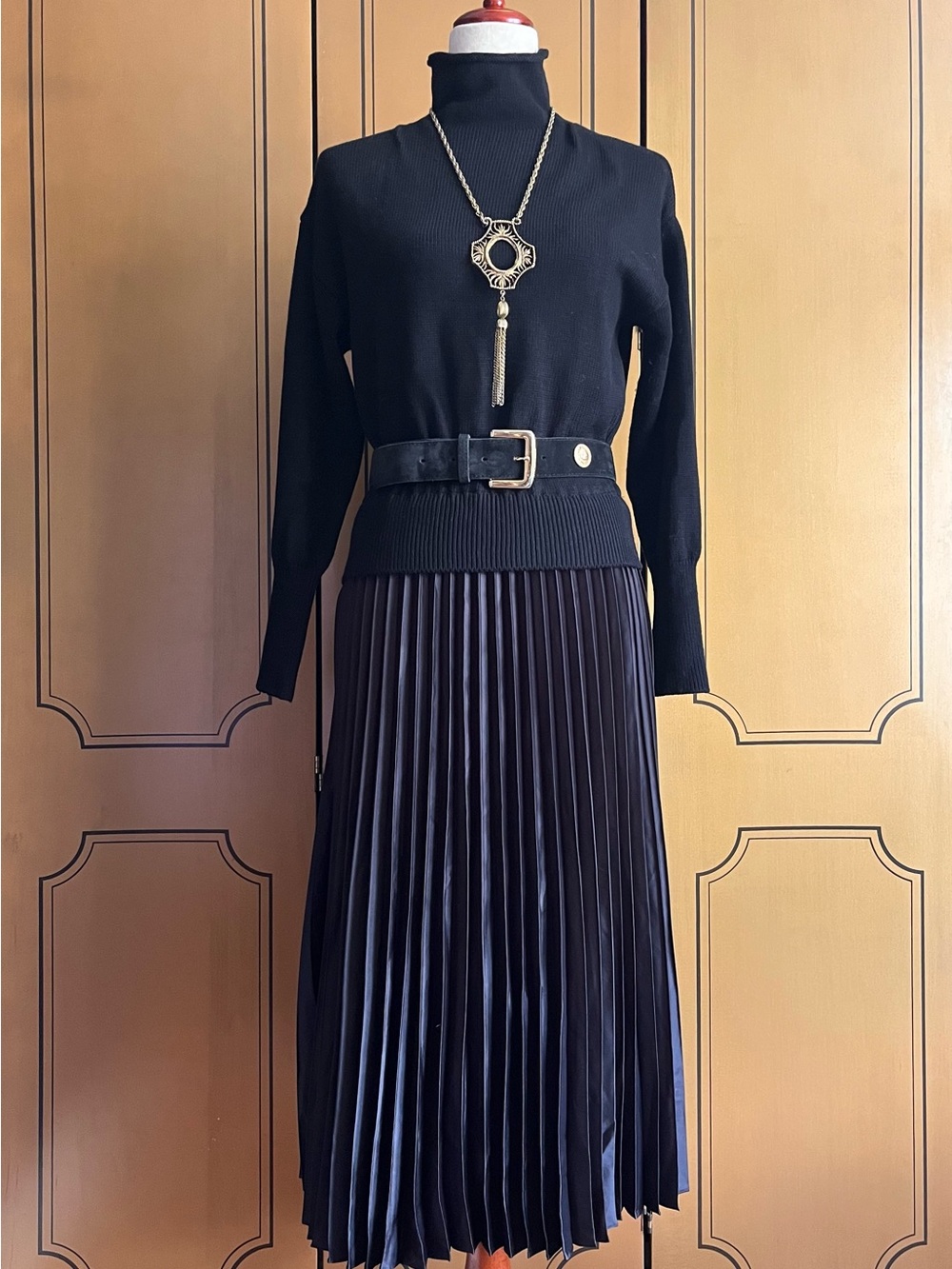 Black dress with knitted top and pleated skirt